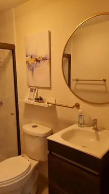 a bathroom with a toilet and a sink and a mirror at Cozy House! San Miguel in San Miguel
