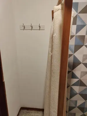 a closet with a towel rack and a wall at Casa FLamenco Suchitoto in Suchitoto