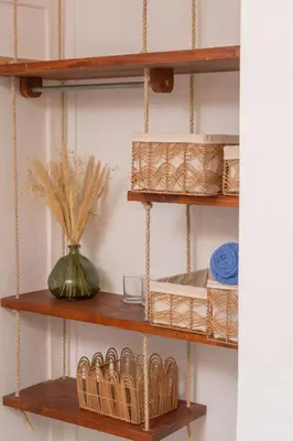 a wooden shelf with baskets and a vase on it at Cadejo Brewing Company El Sunzal in Tamanique