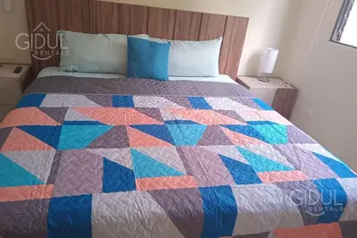 a colorful quilt on a bed in a bedroom at Great San Salvador views at Los Planes wifi and Ac in San Salvador