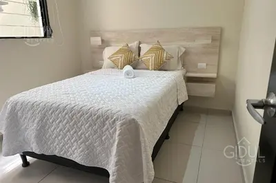 a bedroom with a bed with white sheets and pillows at Great San Salvador views at Los Planes wifi and Ac in San Salvador