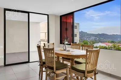 a dining room with a table and chairs on a balcony at Great San Salvador views at Los Planes wifi and Ac in San Salvador