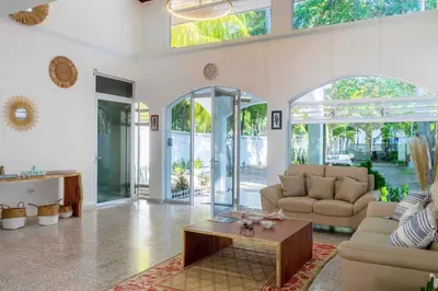 a living room with a couch and a coffee table at Oceanfront Solar Paradise-Steps to the Sea in El Zapote