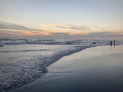 two people standing on a beach with the ocean at Oceanfront Solar Paradise-Steps to the Sea in El Zapote
