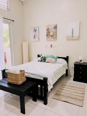 a bedroom with a bed with a basket on it at Oceanfront Solar Paradise-Steps to the Sea in El Zapote