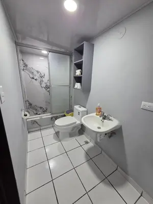 a bathroom with a shower and a toilet and a sink at Mi Tierra Escalón Hotel y Restaurante in San Salvador