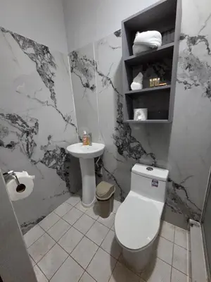 a bathroom with a toilet and a sink at Mi Tierra Escalón Hotel y Restaurante in San Salvador