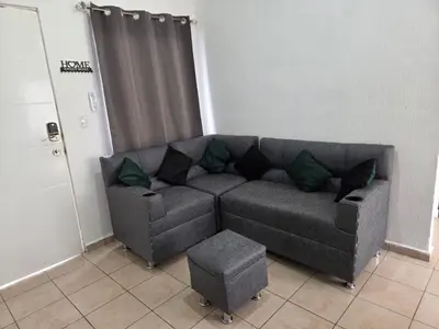 a grey couch in a room with a door at Vista a los Volcanes in Santa Ana