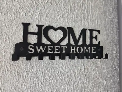 a sign on a wall with the words home sweet home at Vista a los Volcanes in Santa Ana