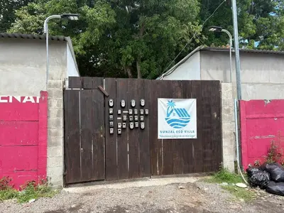 a large wooden gate with a sign on it at La ceibasurf in La Libertad