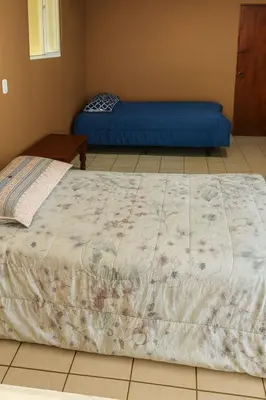 a bedroom with a bed and a blue mattress at Villa Vallarta Costa del Sol in Marcelino