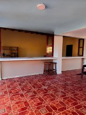 an empty room with a table and a bar at Villa Vallarta Costa del Sol in Marcelino