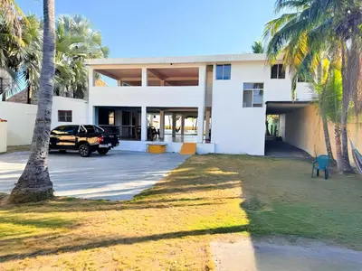 a car parked in front of a building with palm trees at Villa Vallarta Costa del Sol in Marcelino
