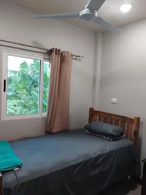 a bedroom with a bed and a window at Villas Oasis Verde in Salcoatitán