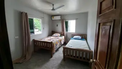 a bedroom with two beds and a window at Villas Oasis Verde in Salcoatitán