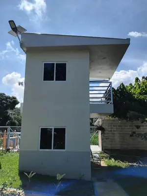a white house with a staircase on the side of it at Villas Oasis Verde in Salcoatitán