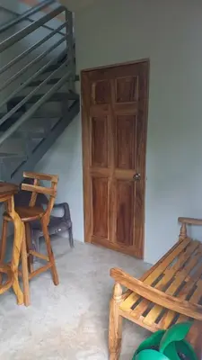 a room with a wooden door and a wooden bench at Villas Oasis Verde in Salcoatitán