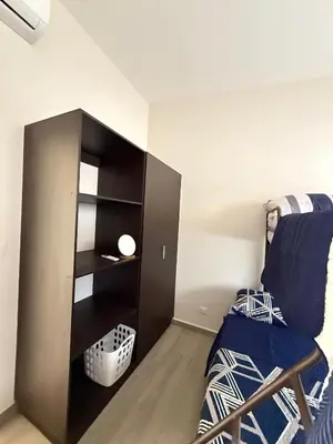 a bedroom with a bed and a book shelf at Luxury Cozy Home in San Miguel