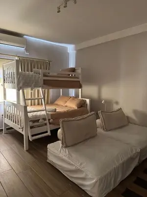 a bedroom with two bunk beds and a crib at Villa del Mar in La Paz