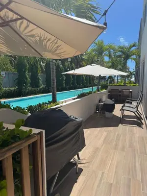 a patio with two umbrellas and a swimming pool at Villa del Mar in La Paz