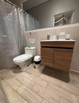 a bathroom with a toilet and a sink at Villa del Mar in La Paz