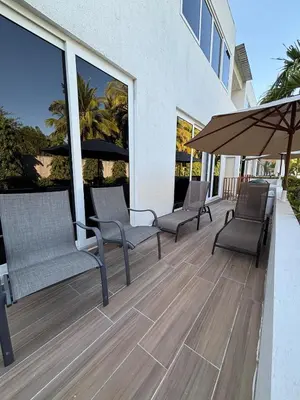 a patio with chairs and an umbrella on a building at Villa del Mar in La Paz
