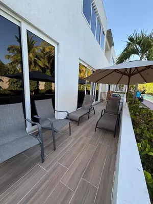 a patio with two chairs and an umbrella at Villa del Mar in La Paz