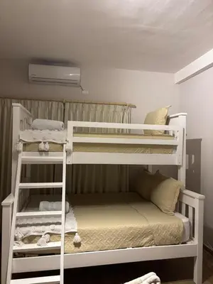 two bunk beds in a small room with a bed at Villa del Mar in La Paz