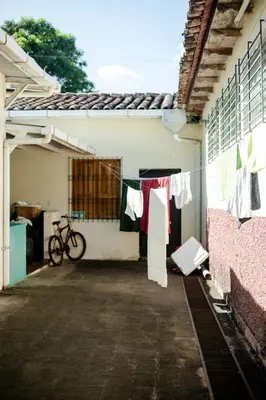 a building with clothes hanging on a clothes line at Hostal Casa del Sol in Suchitoto