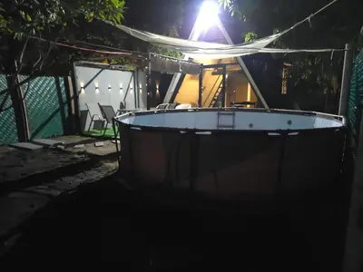 a small boat in the dark at night at Cozy A-Frame Beach Cabin Sihu-A Casa in Las Piedras