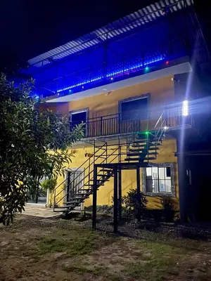 a building with a staircase in front of it at night at Evolution Home in Las Flores