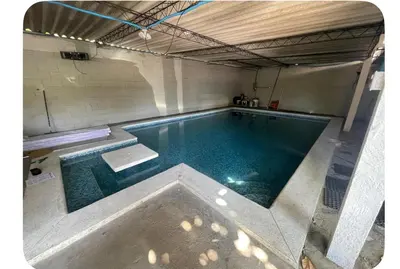 a large swimming pool in a building with at Evolution Home in Las Flores