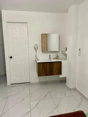 a white bathroom with a sink and a mirror at Evolution Home in Las Flores
