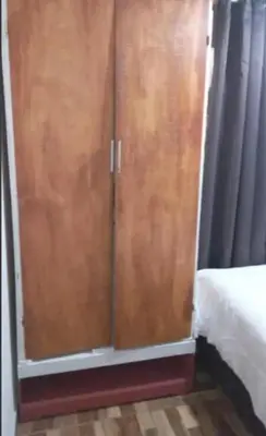 a pair of wooden cabinets next to a bed at Casa completa, cómoda y céntrica in San Salvador