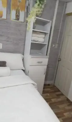 a bedroom with a white bed and a white dresser at Casa completa, cómoda y céntrica in San Salvador