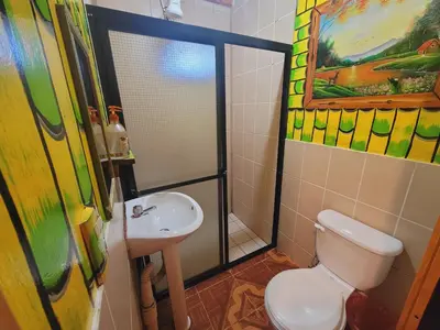 a bathroom with a toilet and a sink at Hostal El Pital Lecho de Flores in Nanastepeque