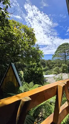 a wooden fence with a dog house on it at Hostal El Pital Lecho de Flores in Nanastepeque