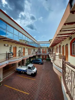 a car parked in a parking lot in front of a building at Hotel Continental Plaza in San Miguel