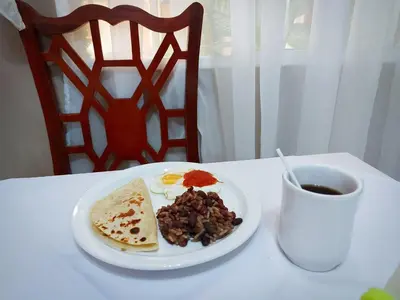 a plate of breakfast food and a cup of coffee at Hotel Continental Plaza in San Miguel
