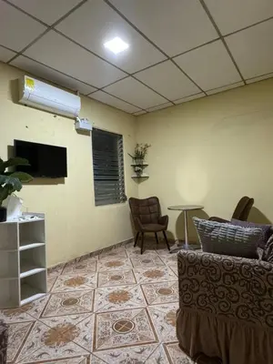 a living room with a couch and a table at Relax House in Sonsonate