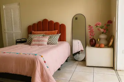 a bedroom with a large bed and a mirror at Galería living in San Salvador
