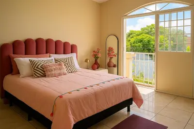 a bedroom with a large bed with a large window at Galería living in San Salvador