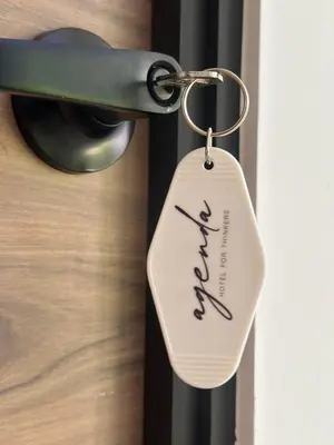 a key tag hanging from a door handle at Agenda Hotel in San Salvador