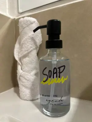 a soap bottle sitting on a sink in a bathroom at Agenda Hotel in San Salvador