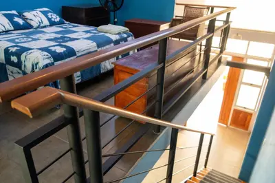 a staircase leading to a room with a bed at Hostal Casa del Sol Apartamento in Suchitoto