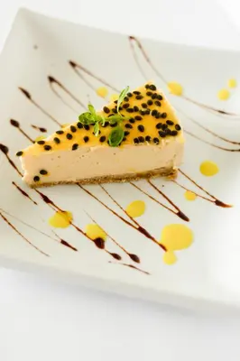 a piece of cheesecake on a white plate at Hostal Casa del Sol Apartamento in Suchitoto