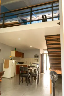 a kitchen and dining room with a table and chairs at Hostal Casa del Sol Apartamento in Suchitoto