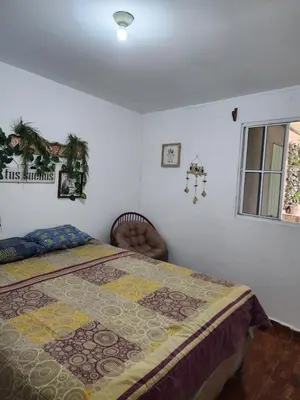 a bedroom with a bed and a window at Casa campo Morales in Apopa