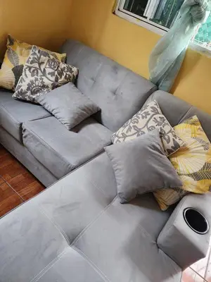a couch with pillows on it in a living room at Casa campo Morales in Apopa
