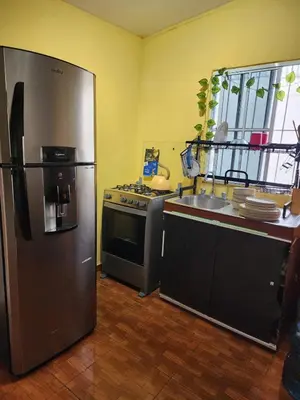 a kitchen with a stainless steel refrigerator and a sink at Casa campo Morales in Apopa
